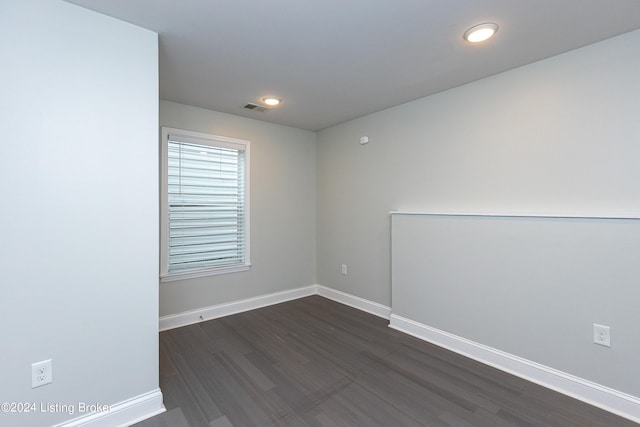 unfurnished room featuring dark hardwood / wood-style flooring