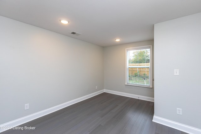 unfurnished room featuring dark hardwood / wood-style floors