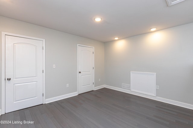 spare room with dark hardwood / wood-style flooring