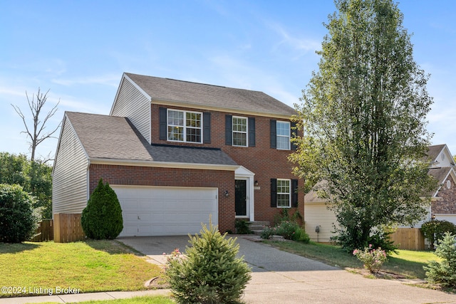 view of front of home featuring a front yard and a garage