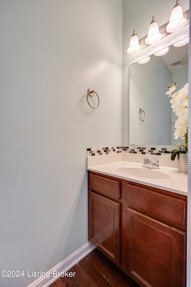 bathroom with vanity and hardwood / wood-style flooring