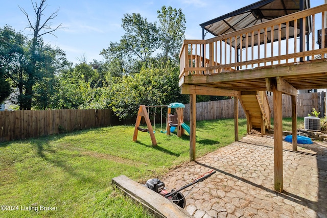 view of yard featuring a playground, a wooden deck, a patio area, and central AC unit