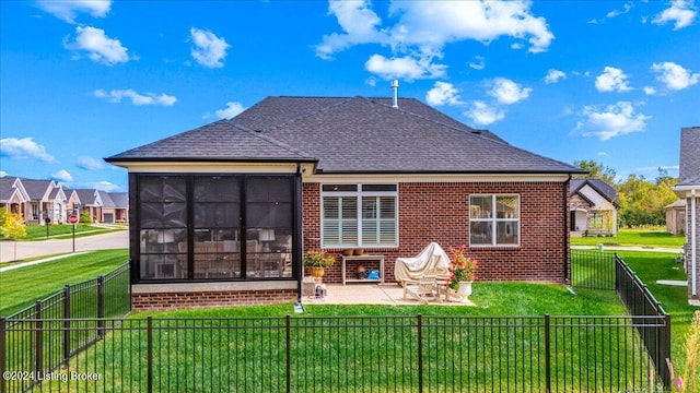 rear view of house featuring a yard and a patio