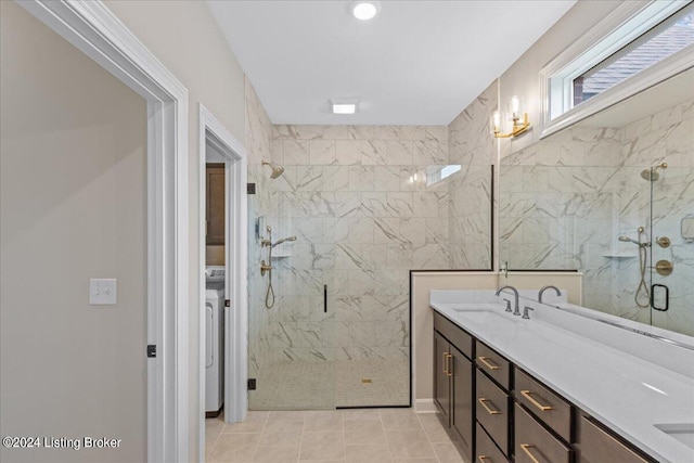 bathroom featuring washer / clothes dryer, vanity, tile patterned flooring, and a shower with door