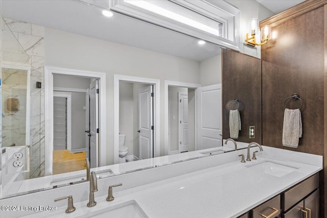 bathroom featuring walk in shower, vanity, and toilet