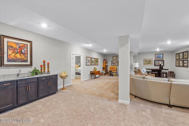 living room with wet bar and light colored carpet