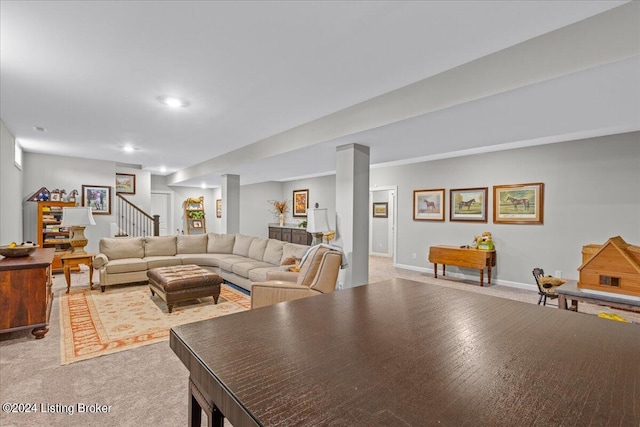 living room featuring light wood-type flooring and decorative columns