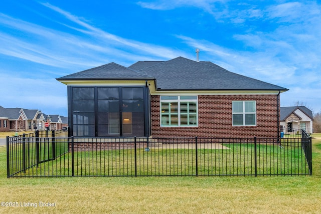 back of house with a lawn