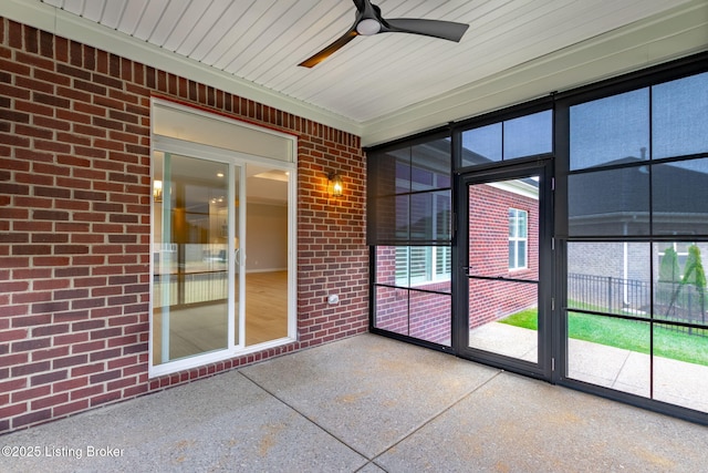 unfurnished sunroom with ceiling fan