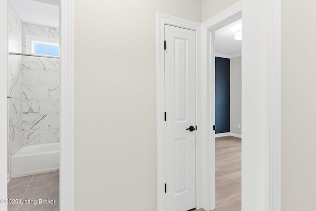 hall featuring crown molding and light wood-type flooring