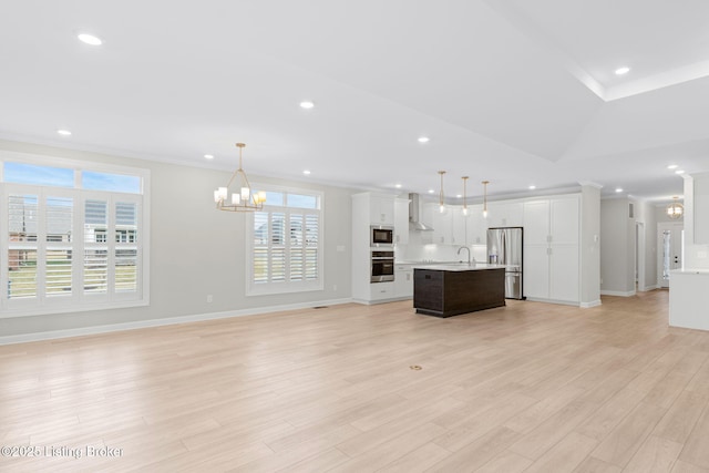 unfurnished living room featuring lofted ceiling, sink, a chandelier, ornamental molding, and light hardwood / wood-style floors