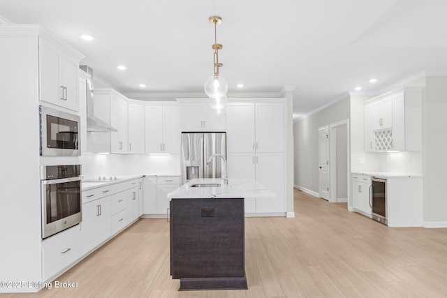 kitchen with wine cooler, appliances with stainless steel finishes, decorative light fixtures, and white cabinets