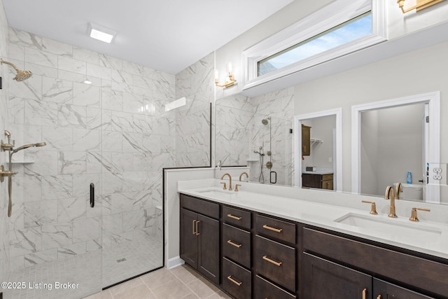 bathroom featuring vanity, tile patterned flooring, and a shower with door