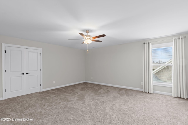 carpeted empty room featuring ceiling fan