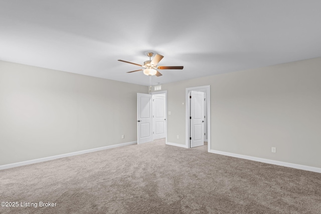 spare room with ceiling fan and carpet