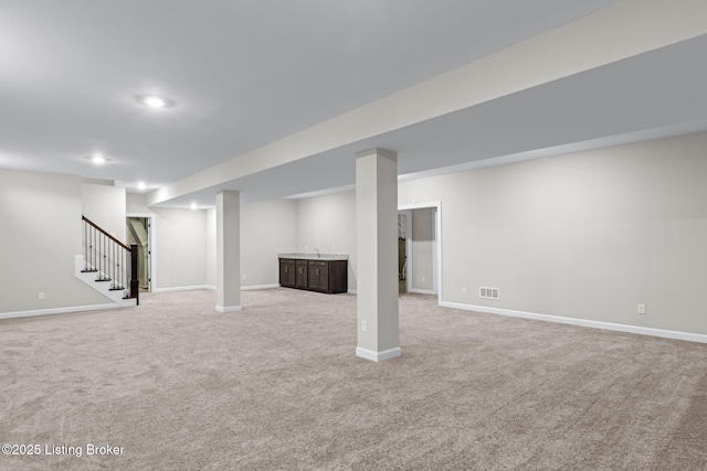 basement featuring light colored carpet