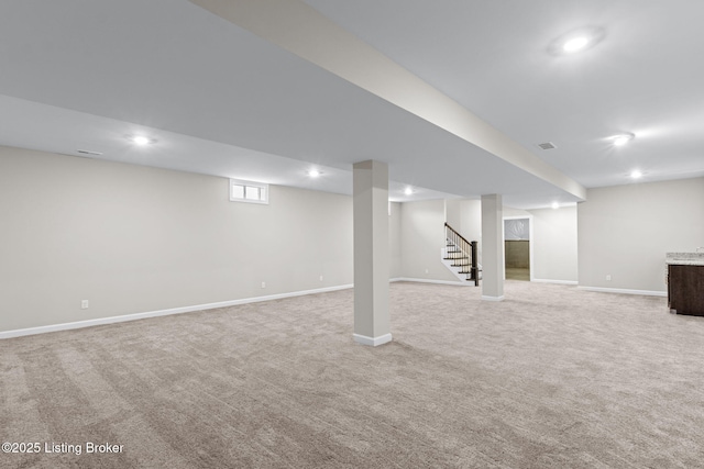 basement featuring light colored carpet