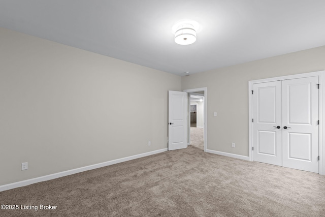 unfurnished bedroom featuring carpet and a closet