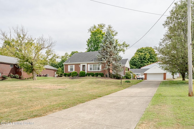 view of front of house with a garage, a front lawn, and an outbuilding