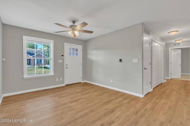 foyer entrance featuring ceiling fan and light wood-type flooring