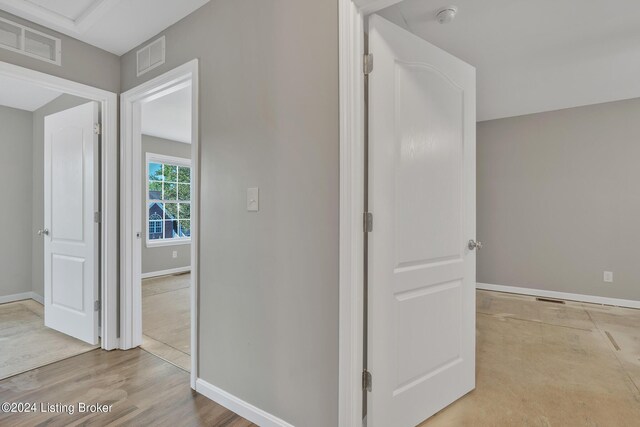 corridor with light hardwood / wood-style floors