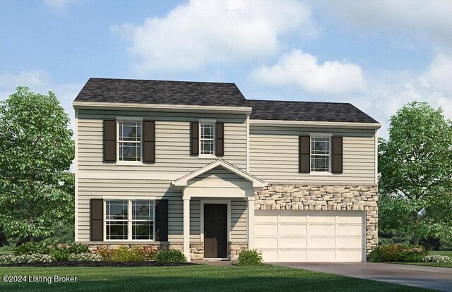 view of front of home with a garage and a front lawn