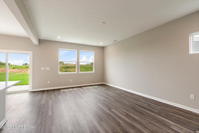 spare room with dark wood-type flooring, baseboards, plenty of natural light, and recessed lighting