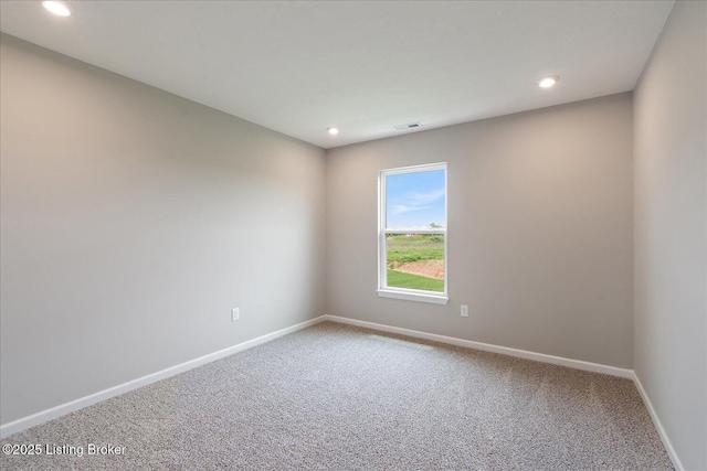 carpeted empty room featuring baseboards and recessed lighting