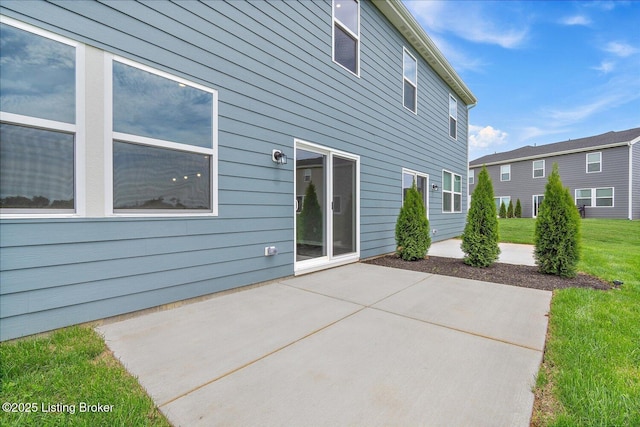 back of property with a patio area and a lawn