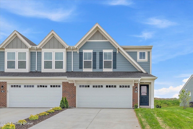view of front of house featuring driveway, brick siding, board and batten siding, and an attached garage