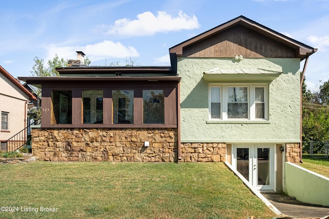 view of front of house featuring french doors and a front lawn