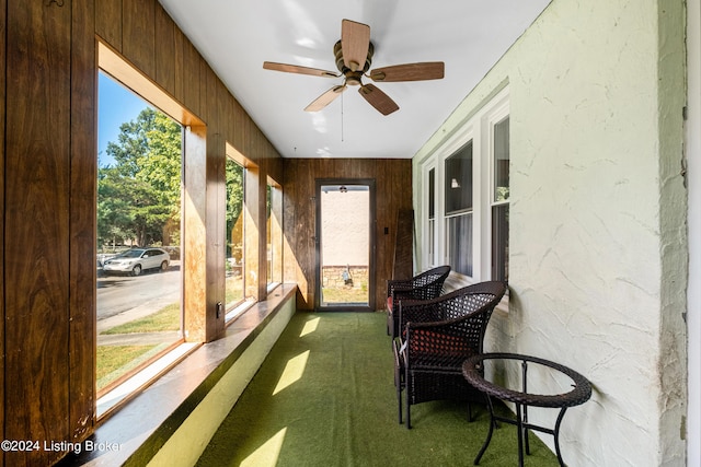 sunroom / solarium featuring ceiling fan