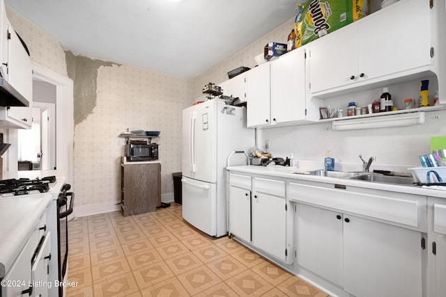 kitchen featuring sink, white appliances, and white cabinets