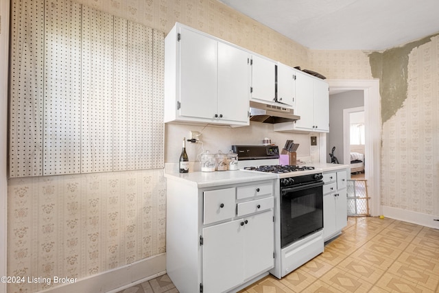 kitchen with gas range gas stove and white cabinets