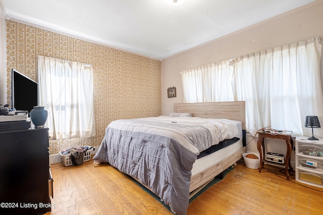 bedroom featuring multiple windows and hardwood / wood-style flooring