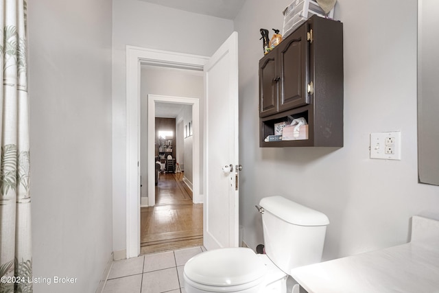 bathroom featuring toilet and wood-type flooring