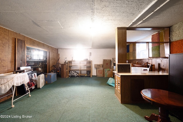 interior space featuring a textured ceiling and wood walls