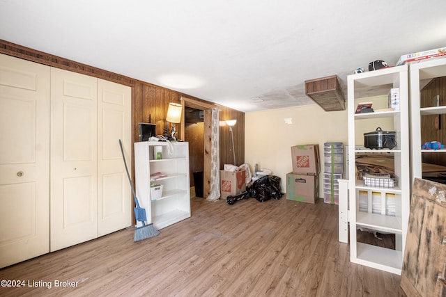 basement with hardwood / wood-style flooring and wood walls