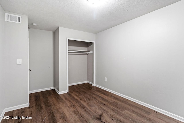 1710 Liberty Bell Way, Louisville, KY 40215 - unfurnished bedroom featuring wood finished floors, a closet, and a textured ceiling