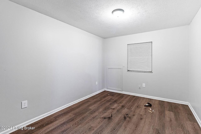 1710 Liberty Bell Way, Louisville, KY 40215 - spare room featuring dark wood-style flooring and a textured ceiling