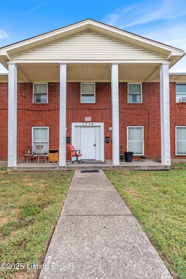 1710 Liberty Bell Way, Louisville, KY 40215 - view of front of house featuring a front yard, brick siding, and covered porch