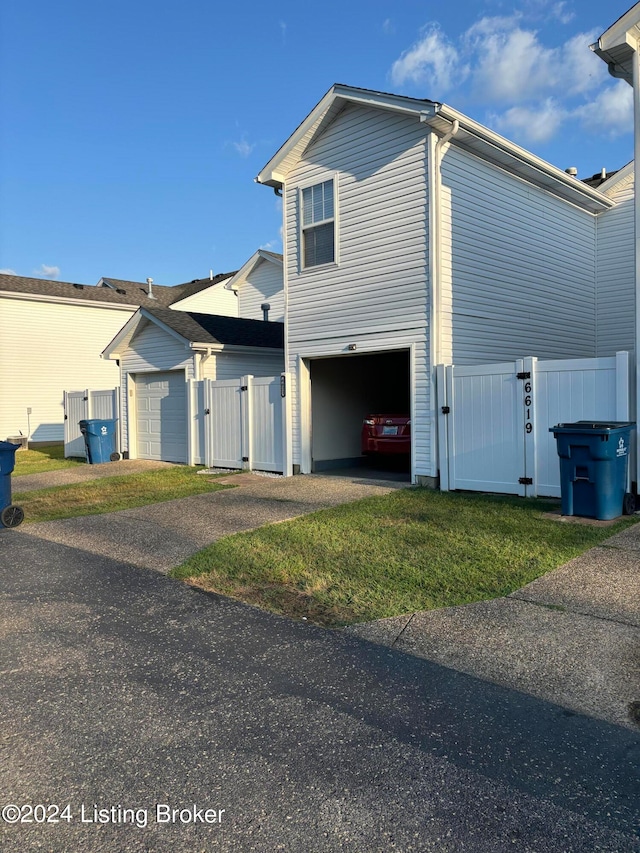 view of front of property featuring a garage and a front lawn