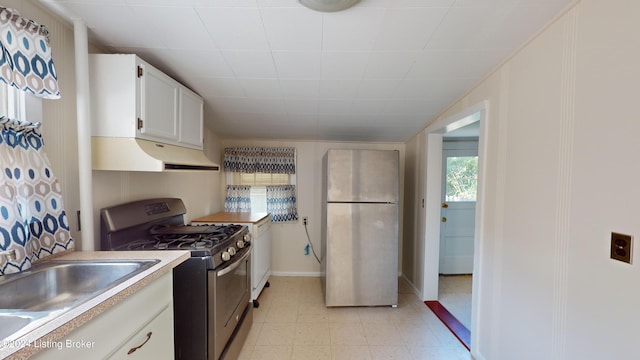 kitchen featuring appliances with stainless steel finishes, white cabinetry, and sink