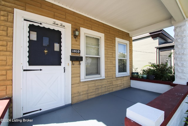 view of exterior entry with a porch