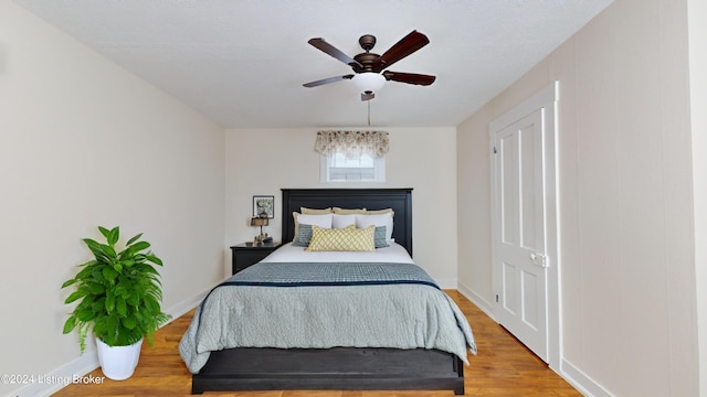 bedroom featuring hardwood / wood-style flooring and ceiling fan