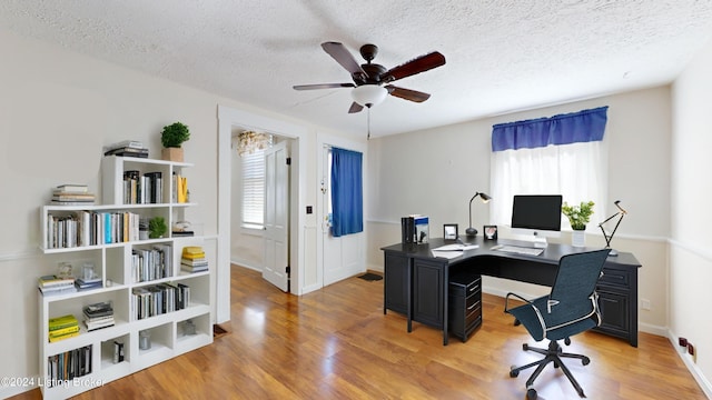 office area with ceiling fan, hardwood / wood-style floors, and a textured ceiling