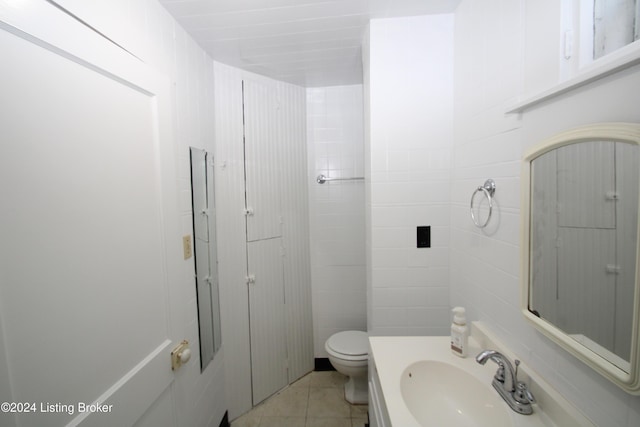 bathroom with tile patterned floors, vanity, and toilet