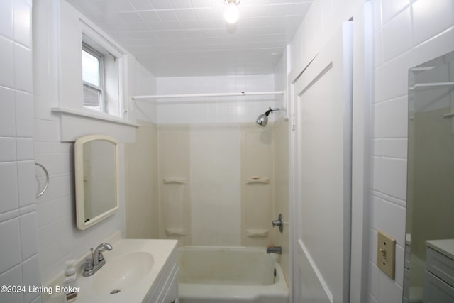 bathroom with shower / bathing tub combination and vanity