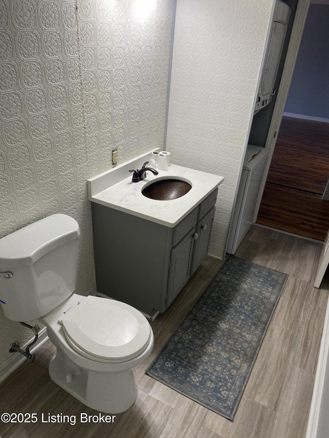 bathroom with vanity, wood-type flooring, and toilet