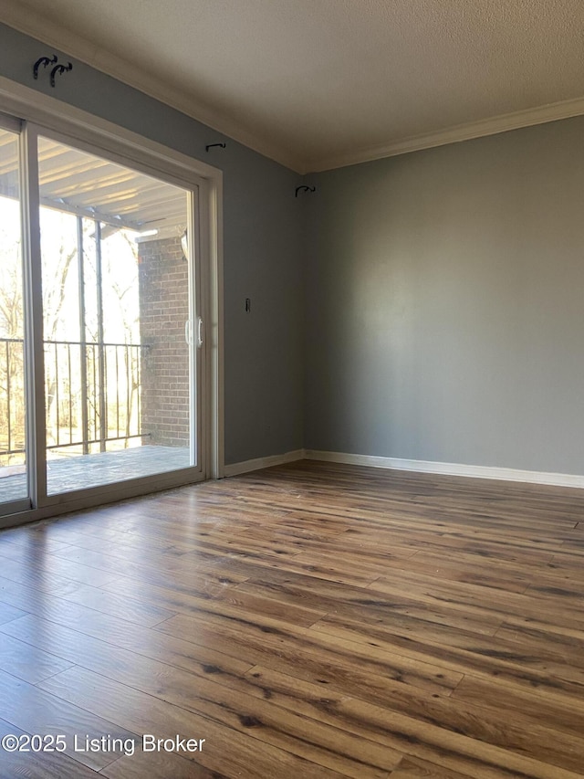 unfurnished room featuring crown molding, hardwood / wood-style floors, and a textured ceiling